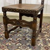 High-backed chair from the early 20th century in oak and leather