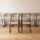 Set of 8 vintage industrial style chairs in metal and wood.