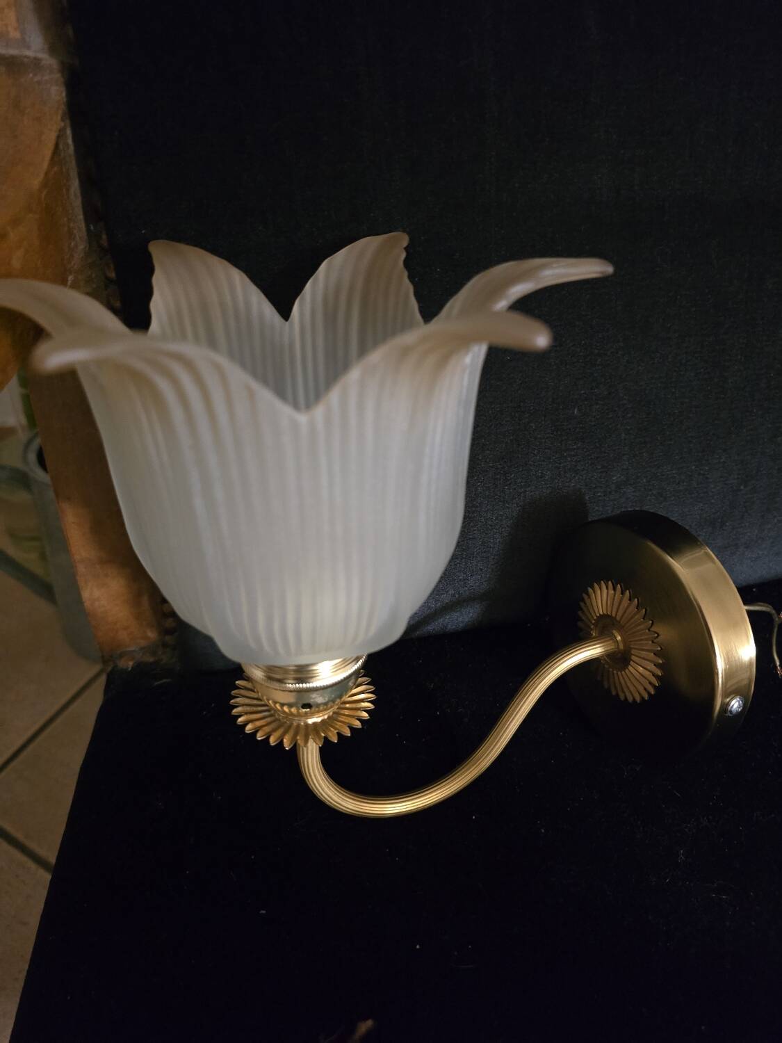 Frosted glass wall sconces and gilded brass in Art Deco style.