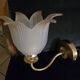 Frosted glass wall sconces and gilded brass in Art Deco style.