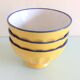 Suite of three yellow ribbed bowls with blue / vintage 70s border