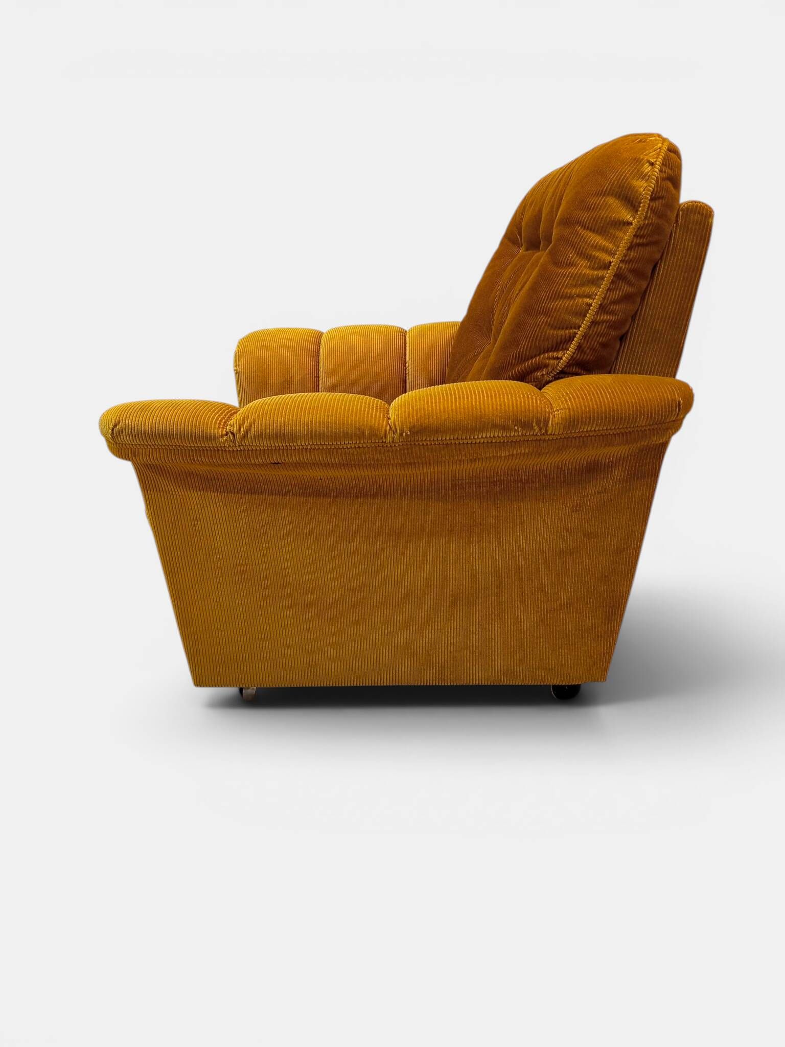 Vintage lounge chair on wheels in golden mustard corduroy 70s