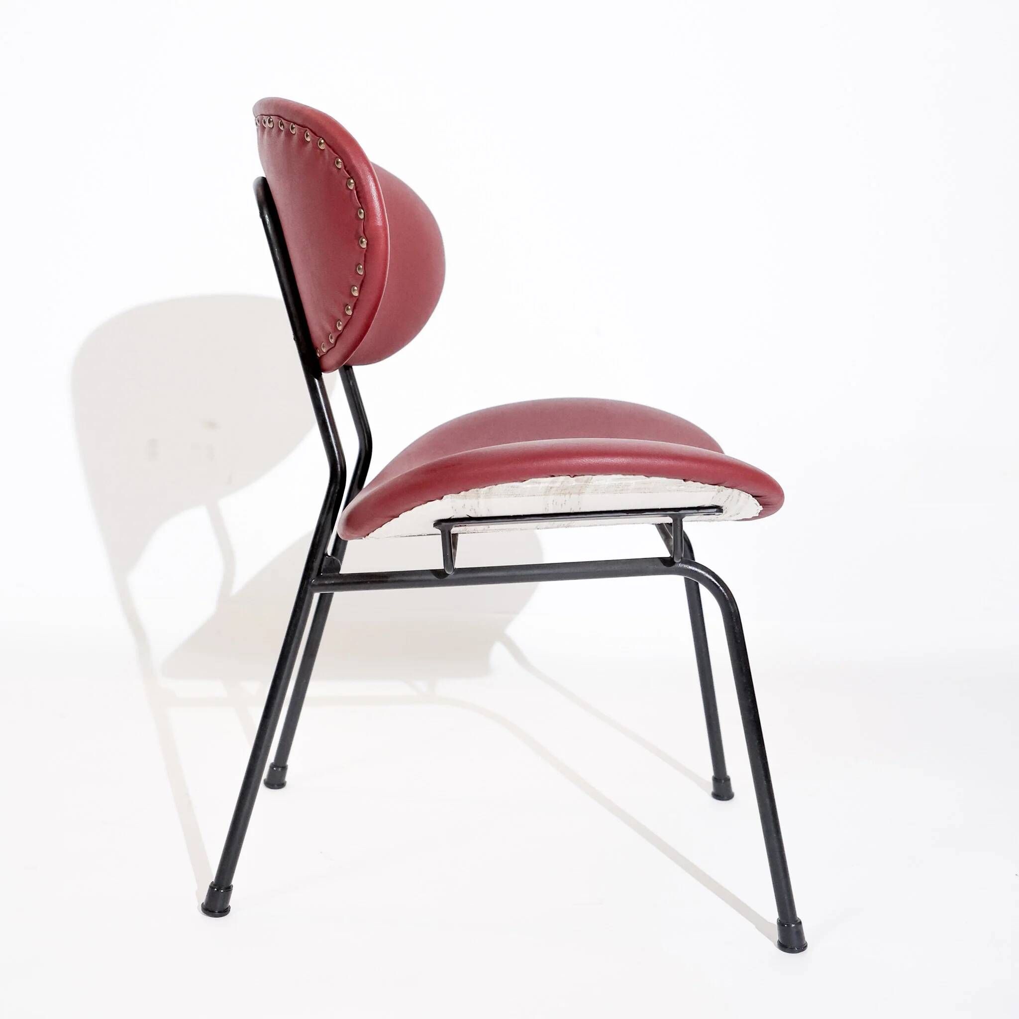Vintage low chair by Gastone Rinaldi for Rima, black lacquered frame and burgundy upholstery, Italy, 1950s.