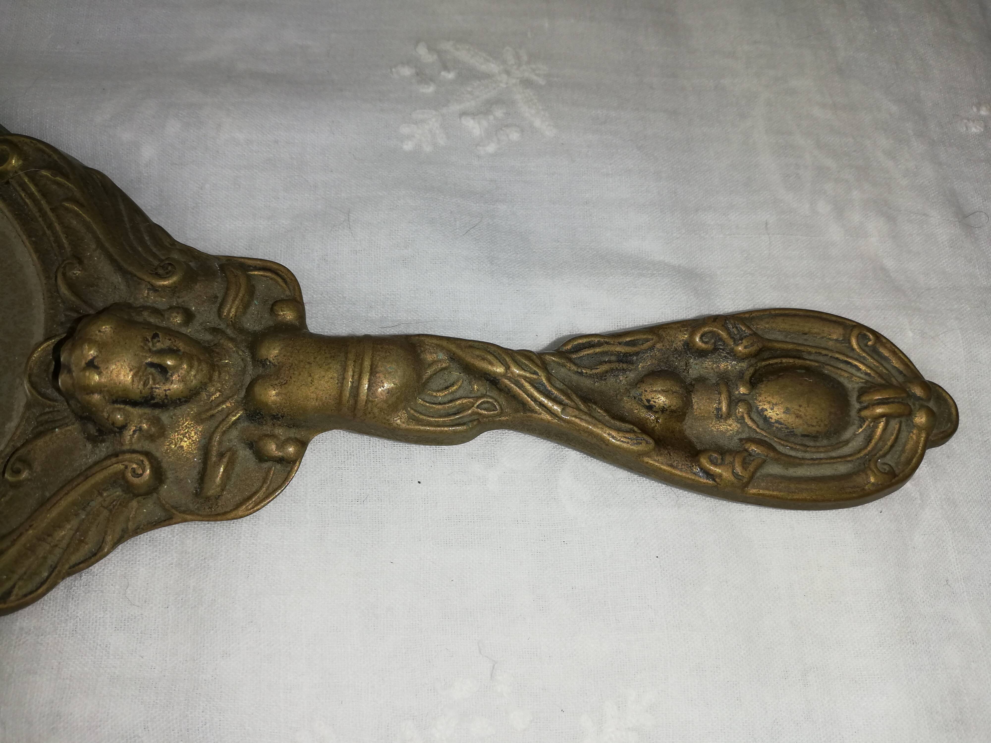 Old hand-facing mirror in gilded bronze