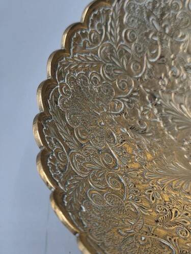 Engraved brass bowl from the mid-20th century with a scalloped edge.