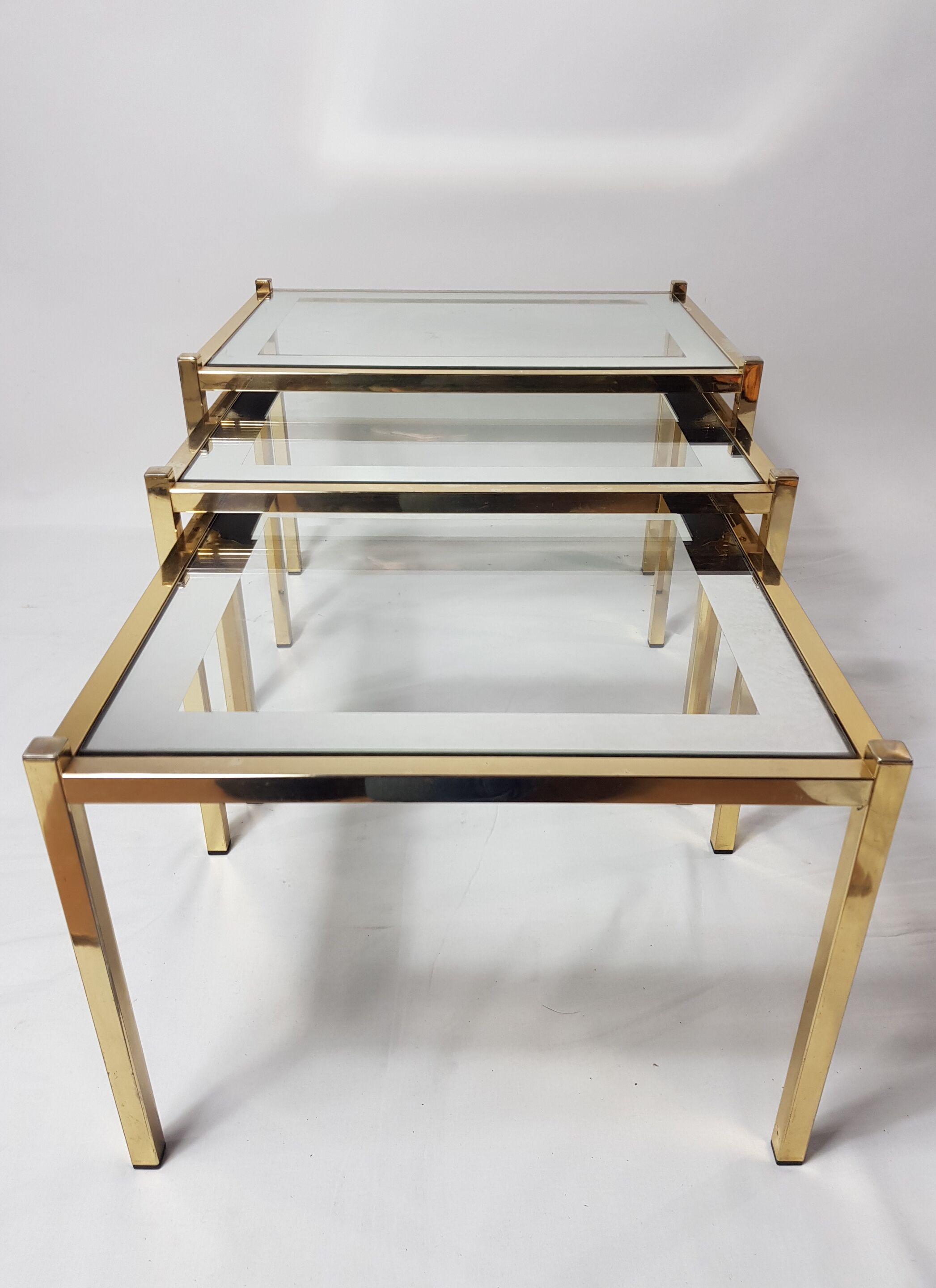 Three trundle tables gilded brass and silver 60s