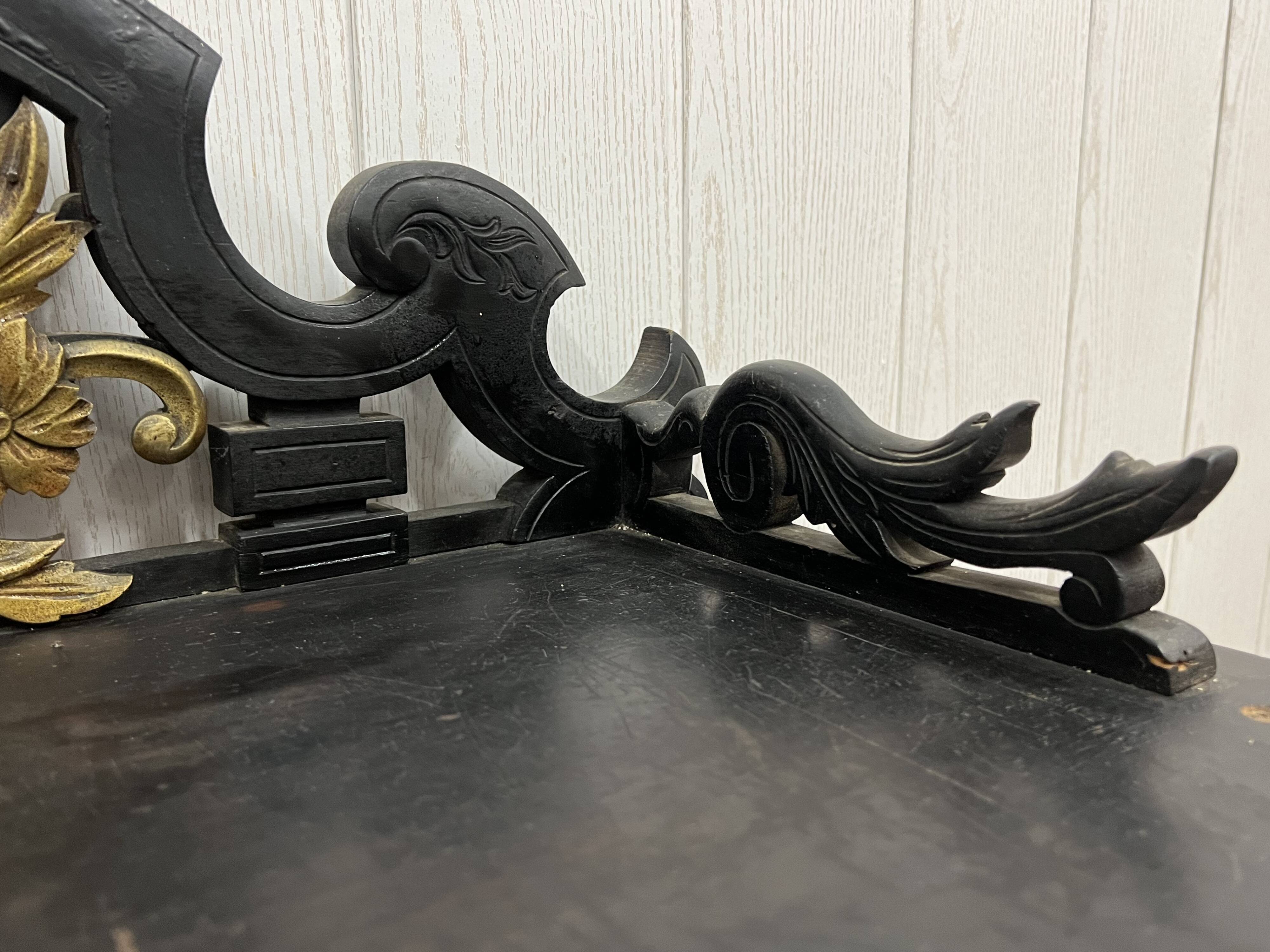 Blackened wooden shelf.