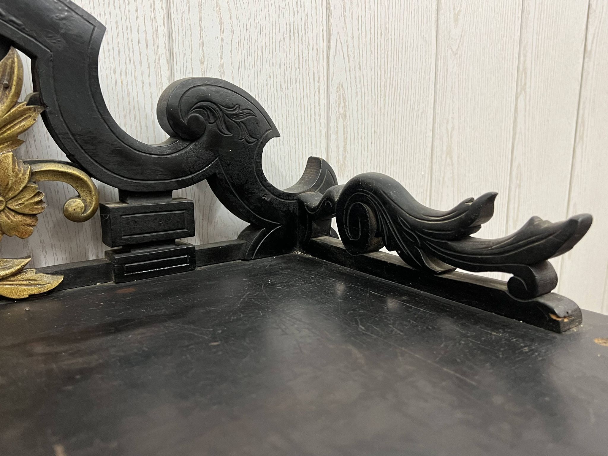 Blackened wooden shelf.