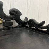 Blackened wooden shelf.