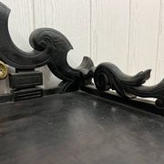 Blackened wooden shelf.