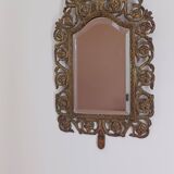 19th century beveled mirror with metal decor