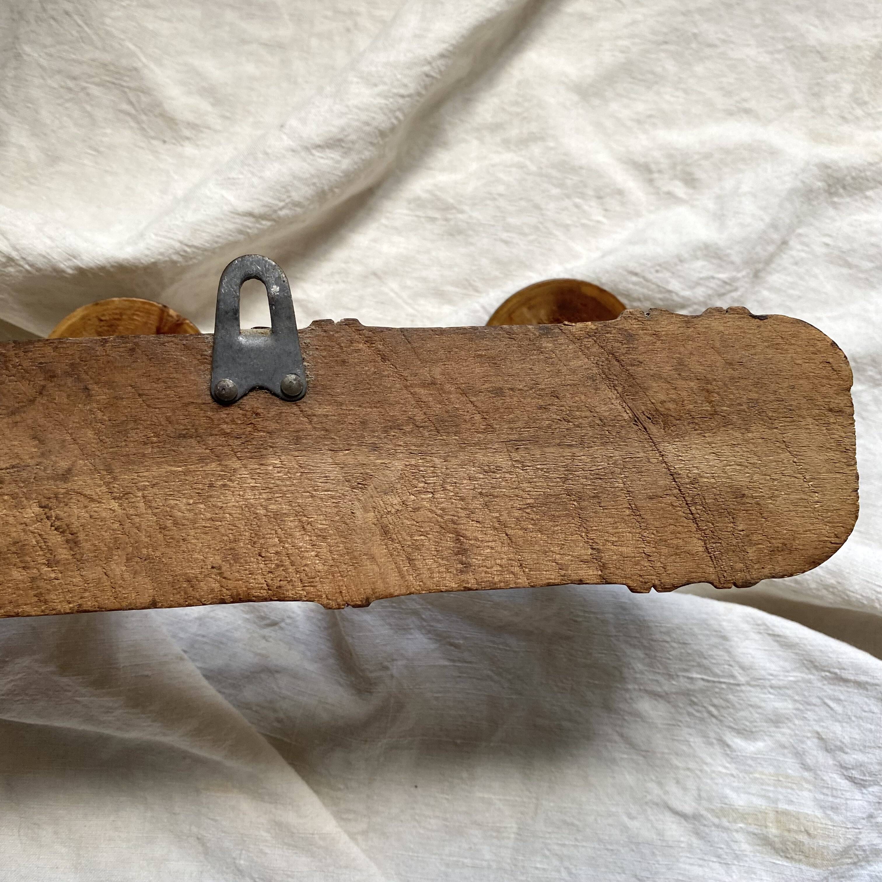 Antique wall-mounted coat rack in turned bamboo-style wood