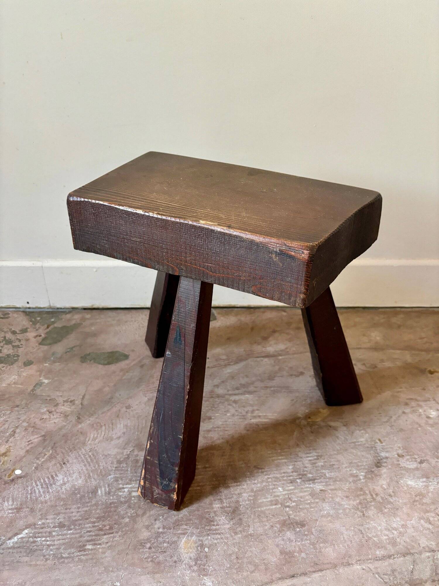 Brutalist tripod stool in dark wood