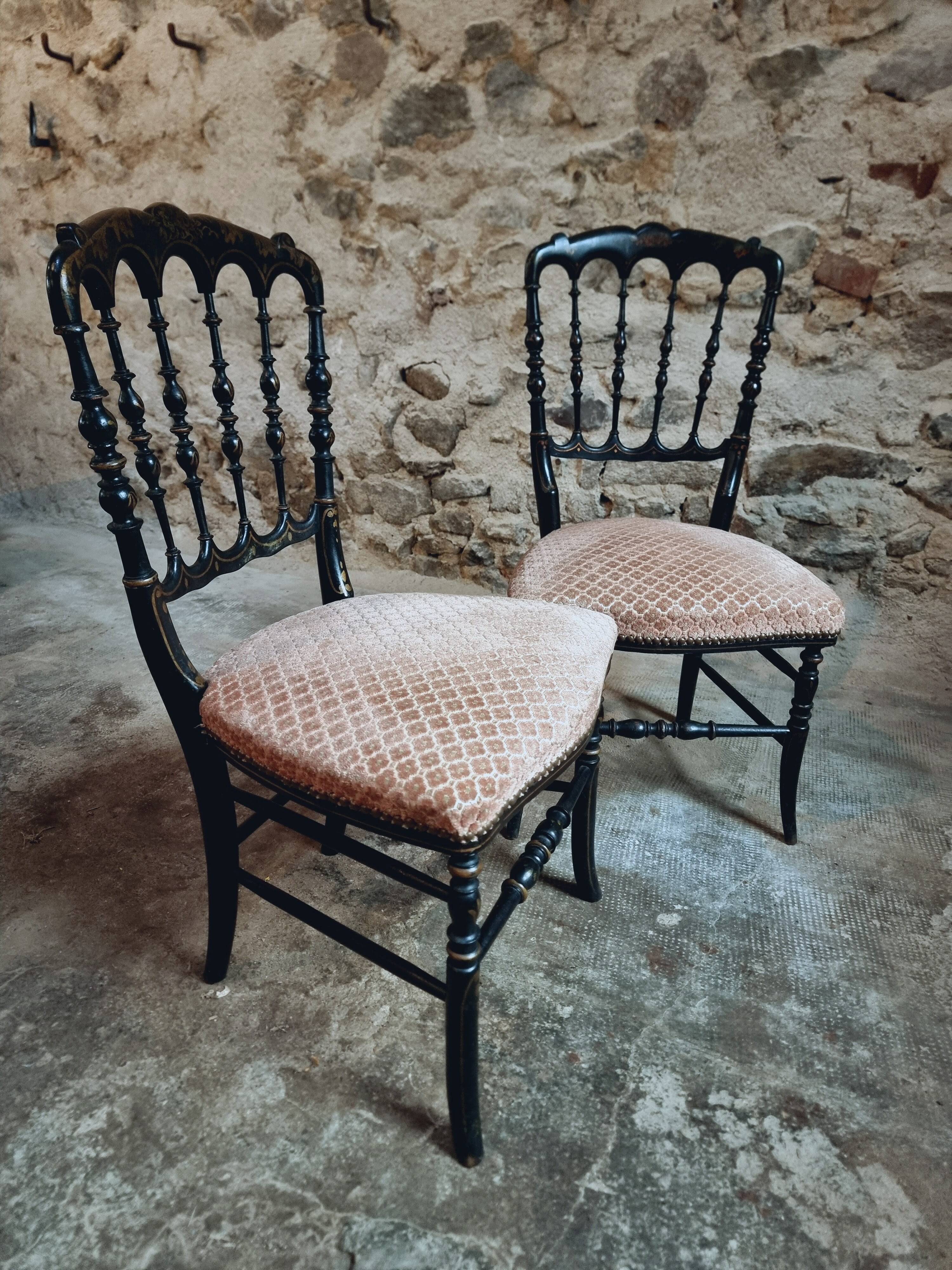 Pair of antique Napoleon III chairs in blackened wood and fabric.