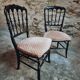 Pair of antique Napoleon III chairs in blackened wood and fabric.