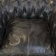 Spacious black cow leather chesterfield armchair with distinctive character