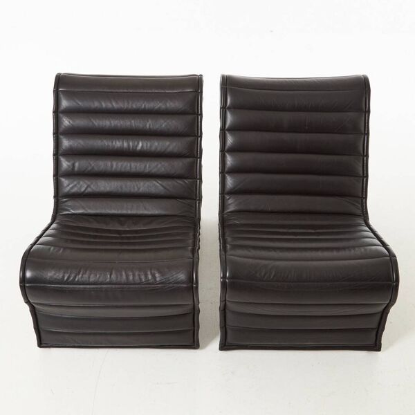 Modern black leather lounge chairs with an aluminium frame.