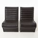 Modern black leather lounge chairs with an aluminium frame.