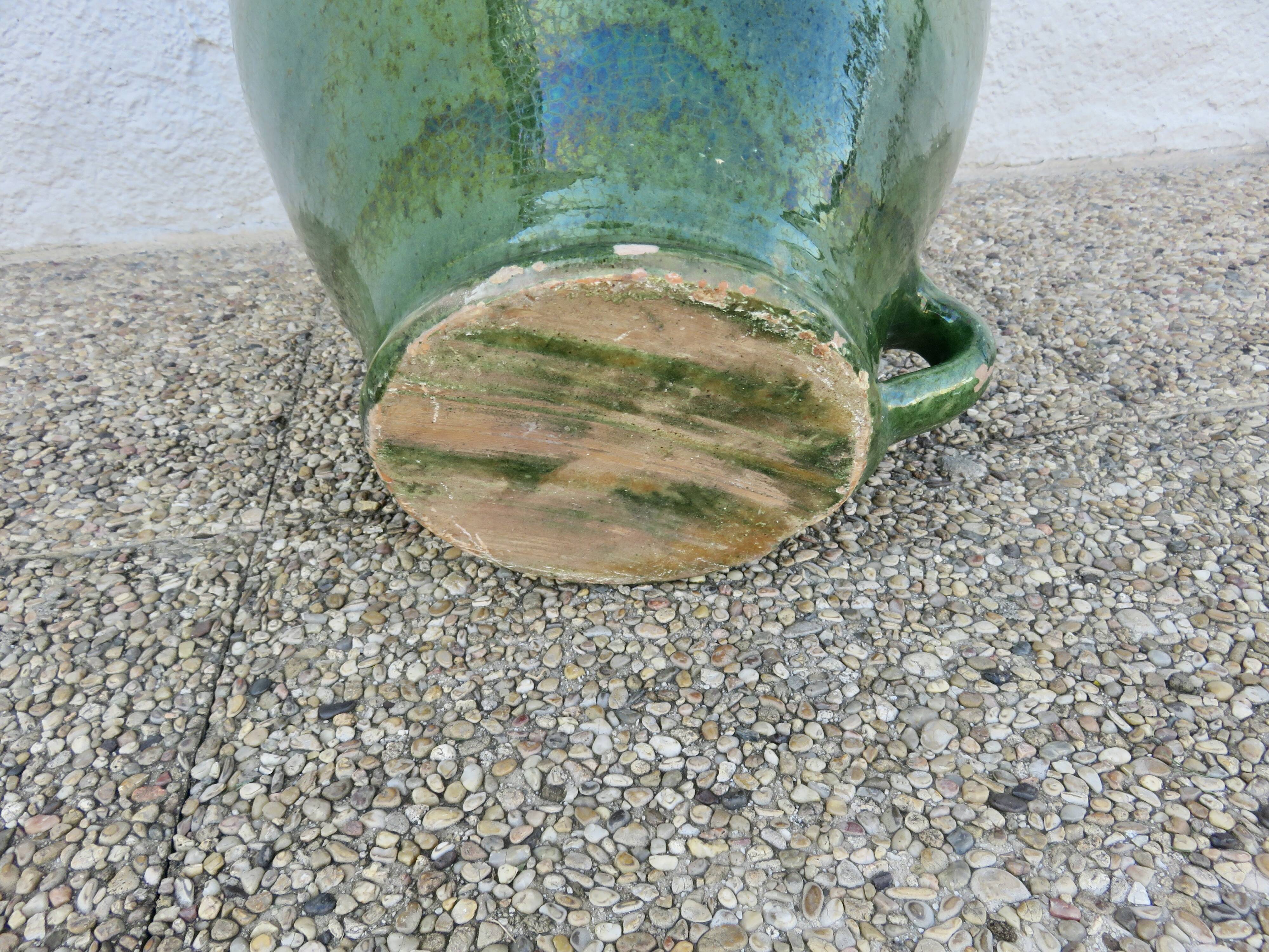 Antique glazed green terracotta oil jar, late 19th century.