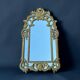 Large mirror with carved and gilded wooden frame, in Regency style.