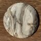 Tray, circular dish or plate made of white striped grey petrified wood.