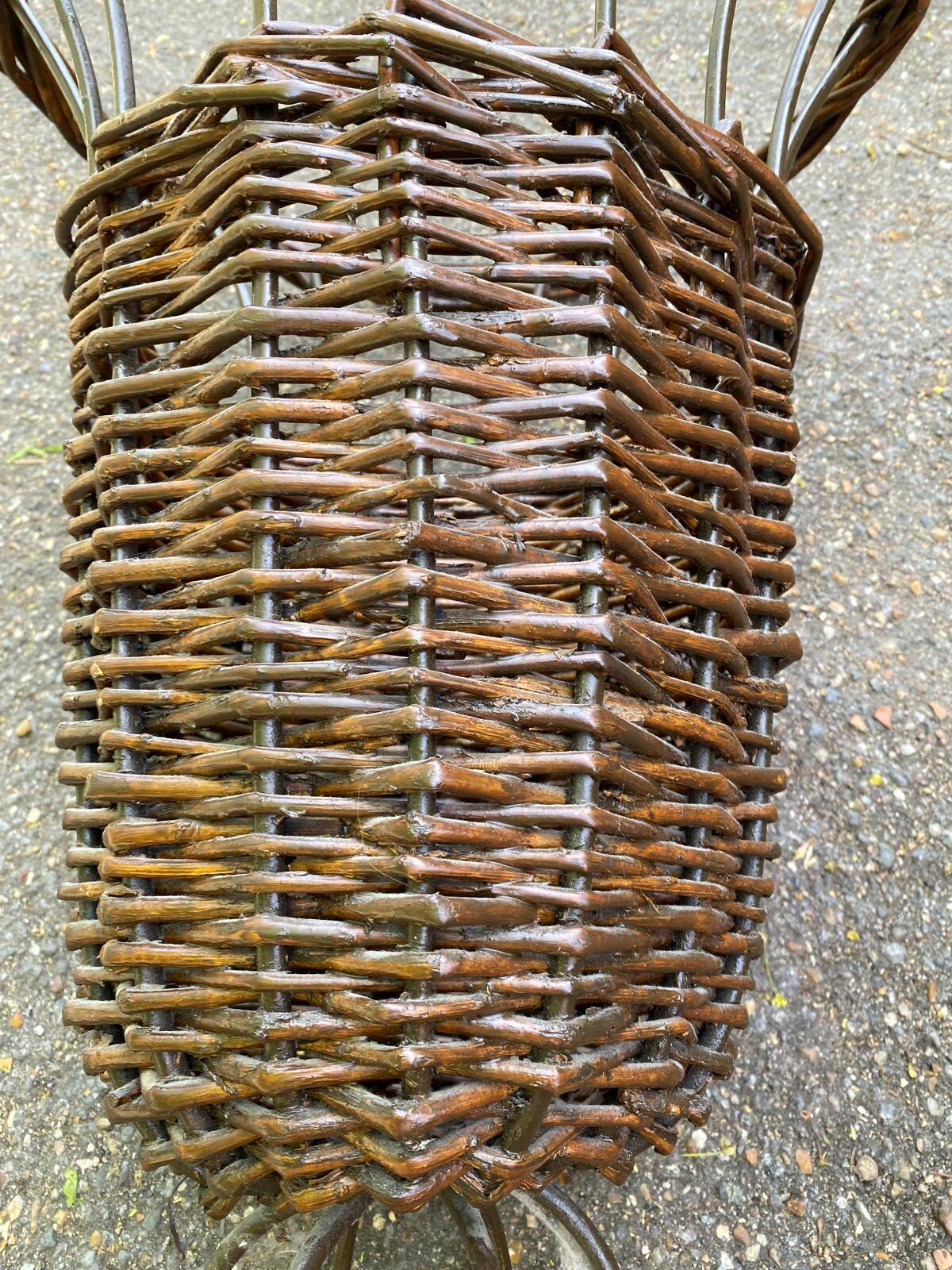 Vintage umbrella stand in rattan, woven wicker, and steel.