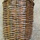 Vintage umbrella stand in rattan, woven wicker, and steel.