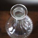 Round-bellied glass carafe with ribbed neck.