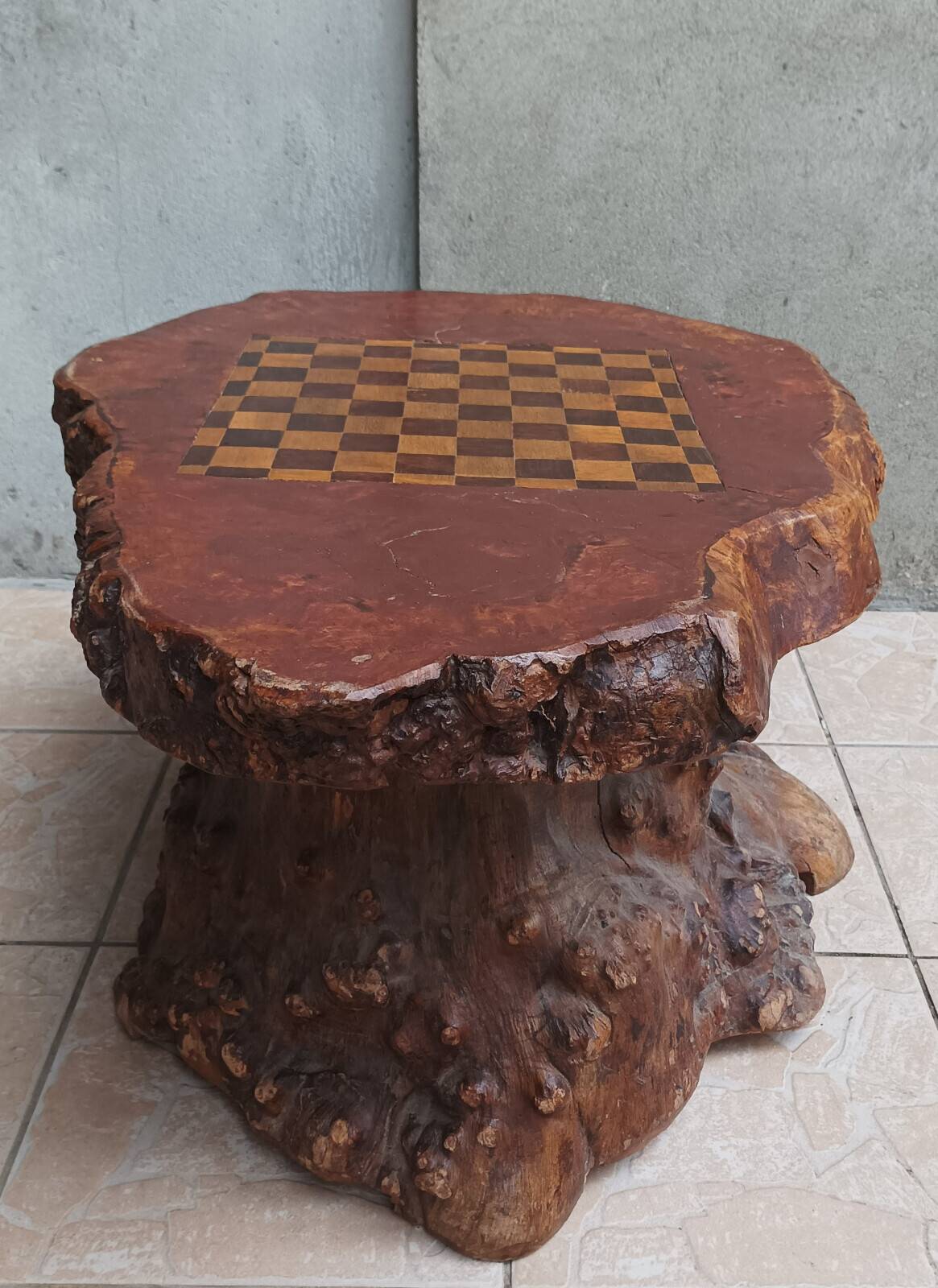 Brutalist chessboard coffee table made from tree stump.
