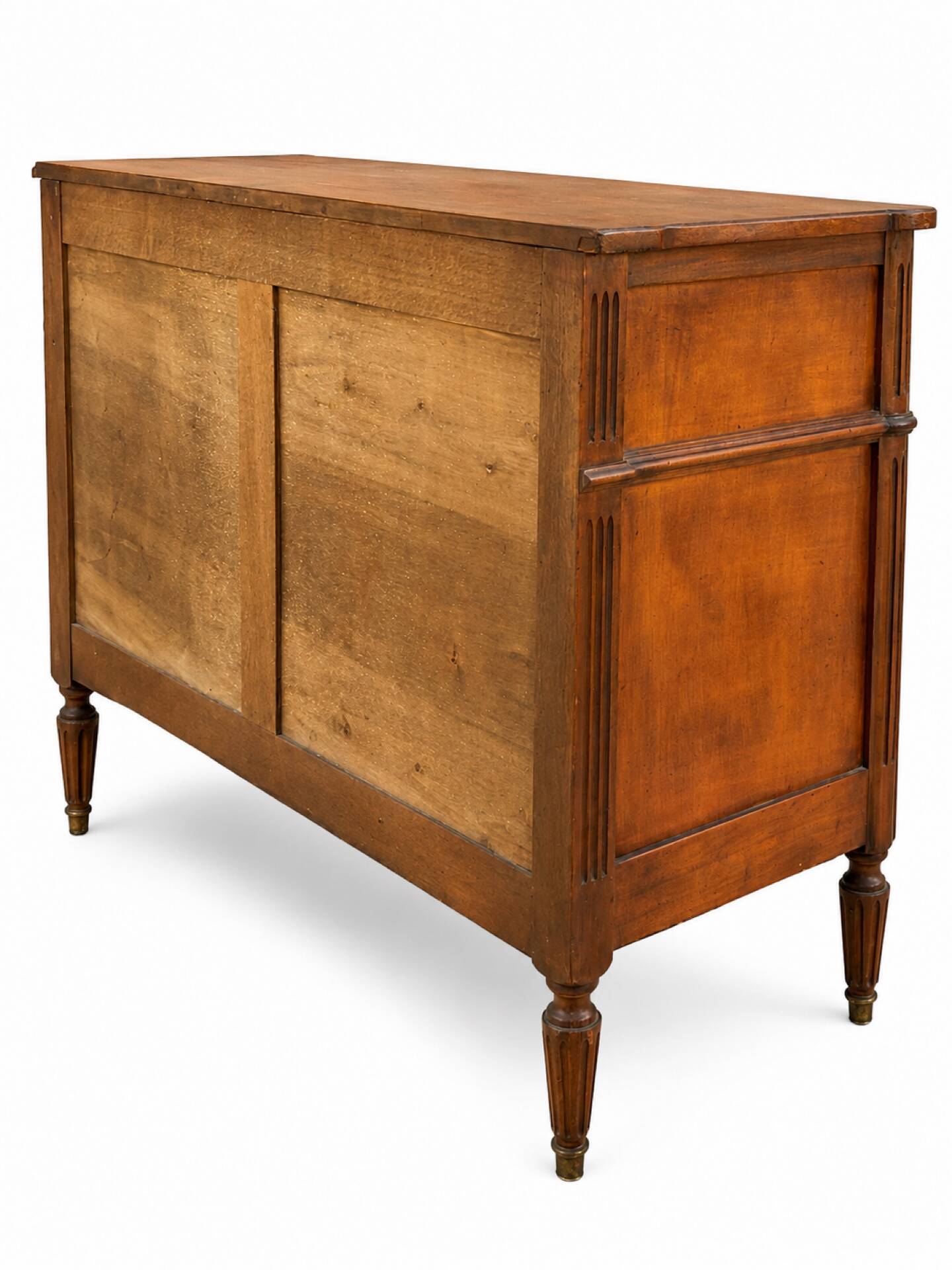 Light walnut commode in Louis XVI style with fluted motifs and three drawers.