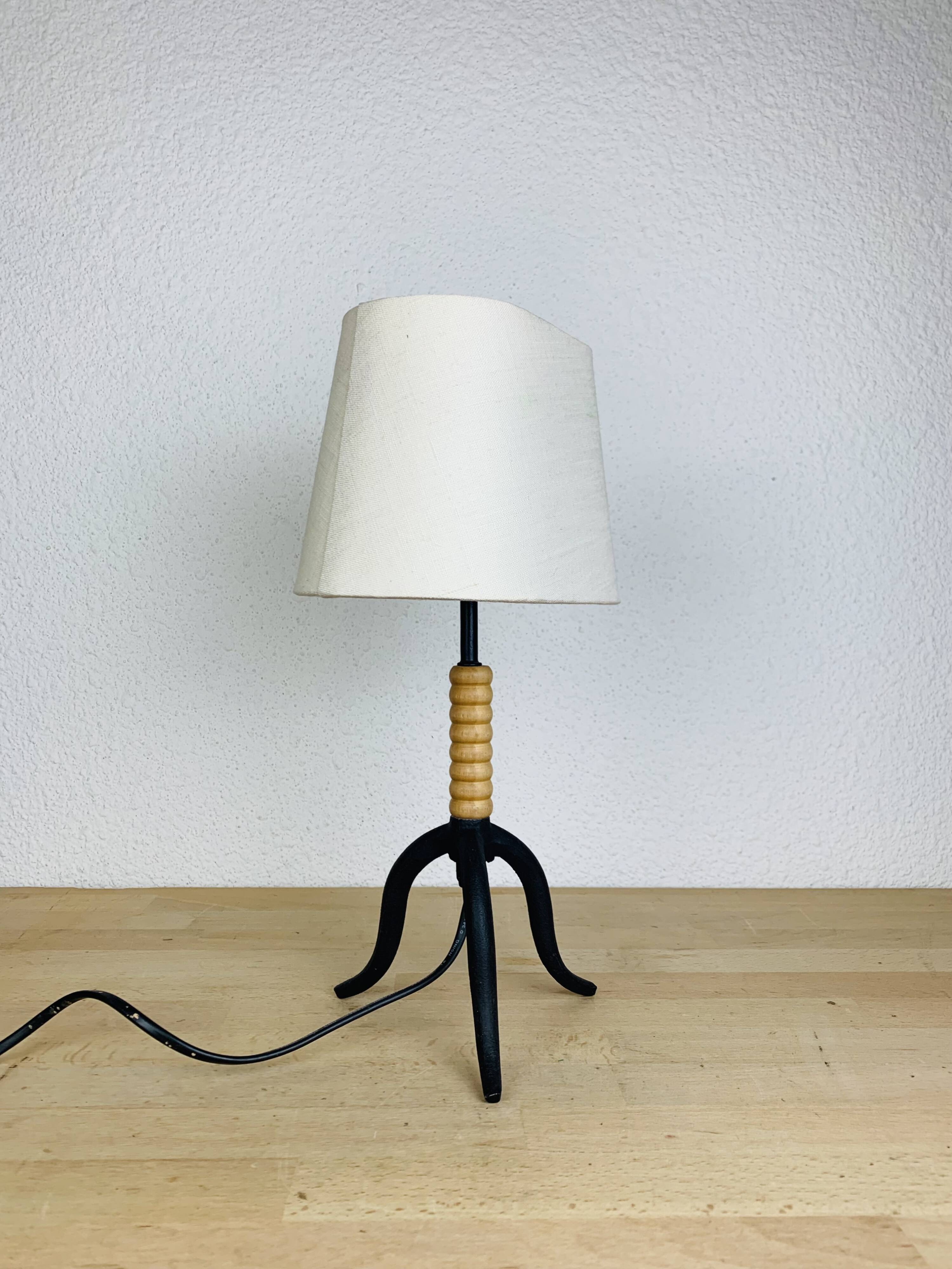 Wrought iron and wood tripod lamp