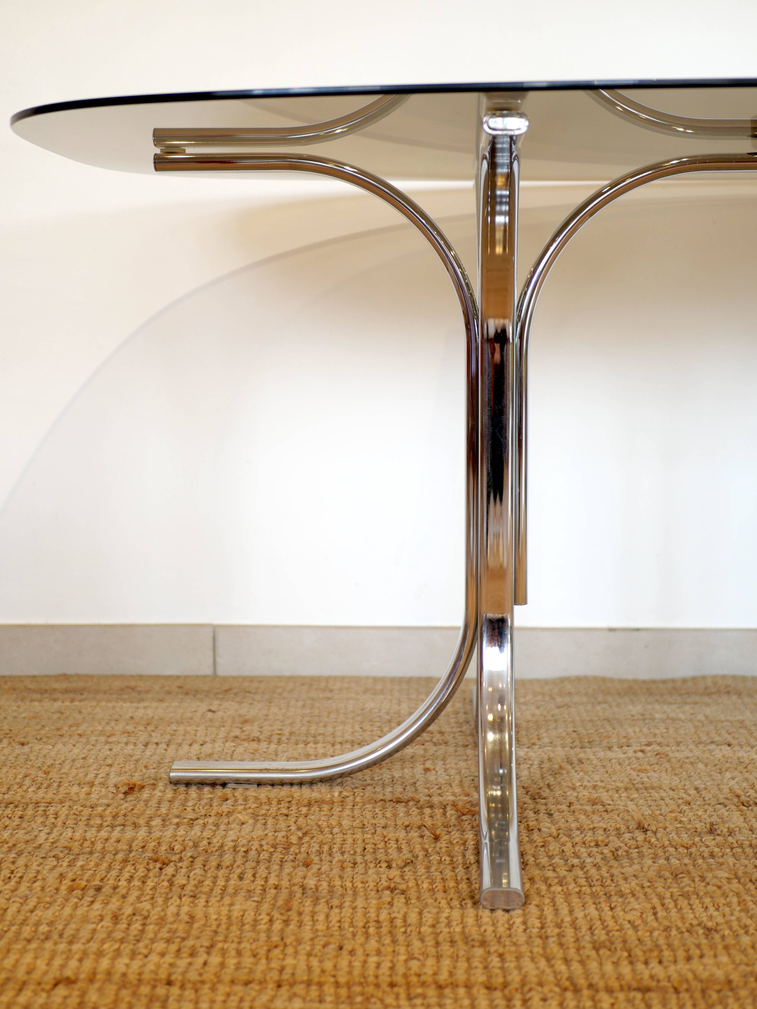 Dining table with smoked glass top and chrome base.