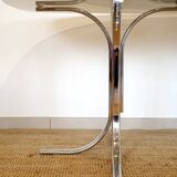 Dining table with smoked glass top and chrome base.