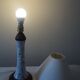 Table lamp for bedside use in earthenware with a wooden base.