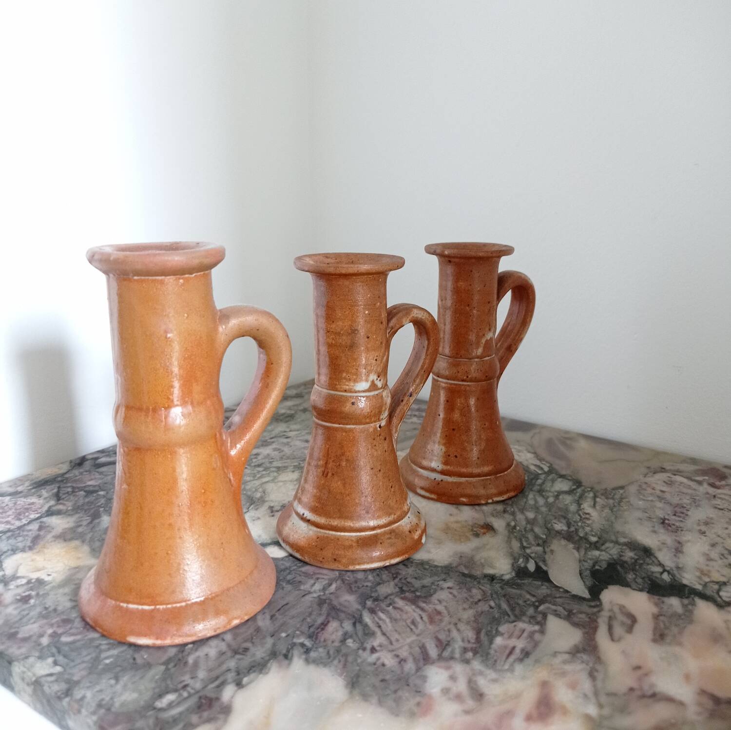 Enamelled stoneware candle holders