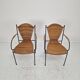 Pair of wicker and iron armchairs by Frederic Weinberg, United States, 1950s.