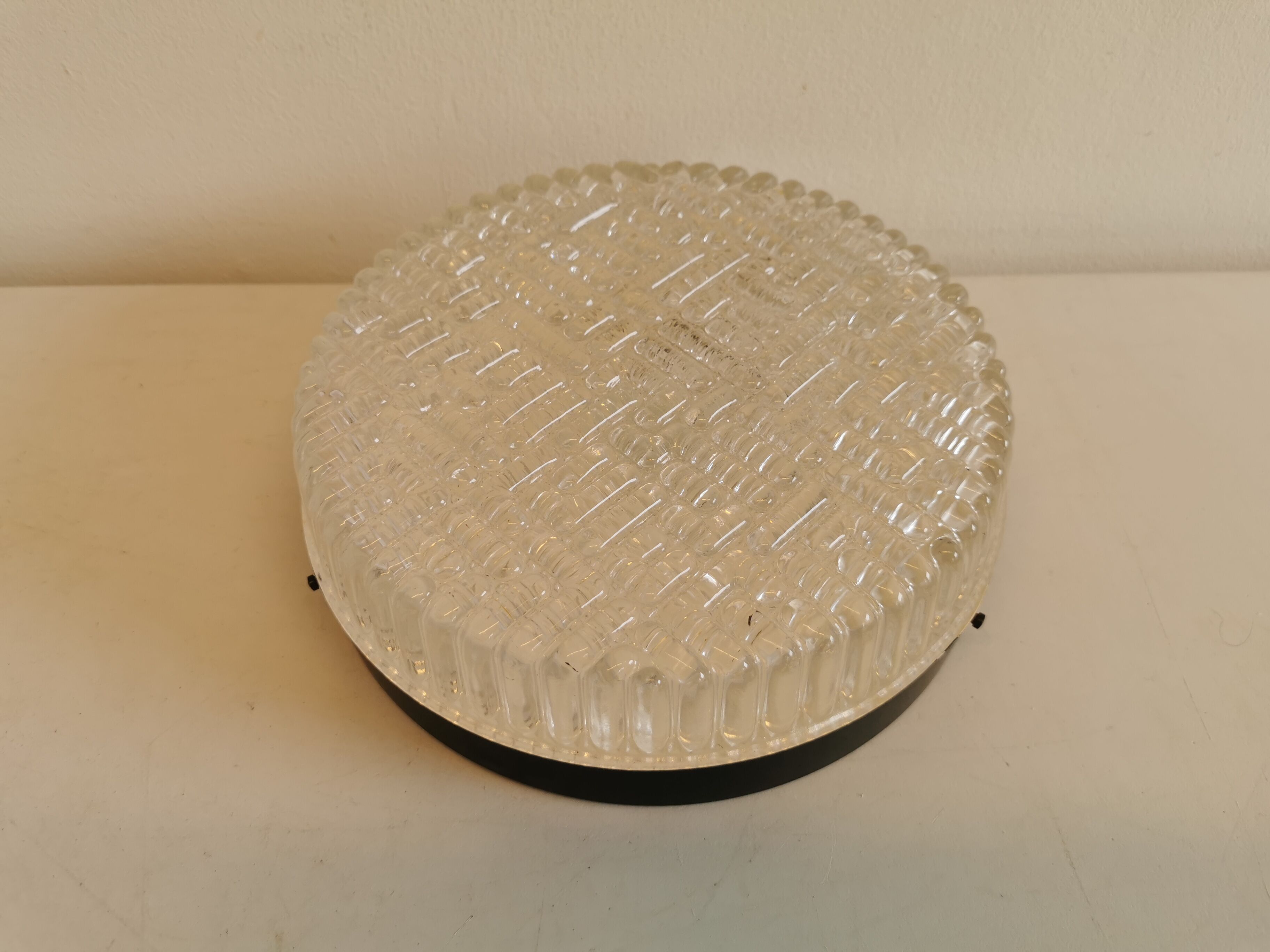 Ceiling light, in dark metallic paint with thick glass shade with beautiful details in the glass.