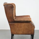 Large and comfortable sheepskin leather wingback chair with black piping