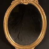 Large oval mirror in gilded wood