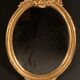 Grand miroir ovale en bois doré