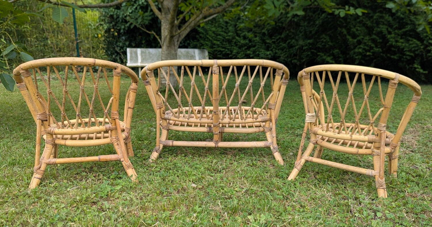 Set of children's rattan garden furniture from the 1950s and 1960s, including chairs, table, and bench.
