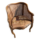 Fauteuil en bois sculpté et cannage