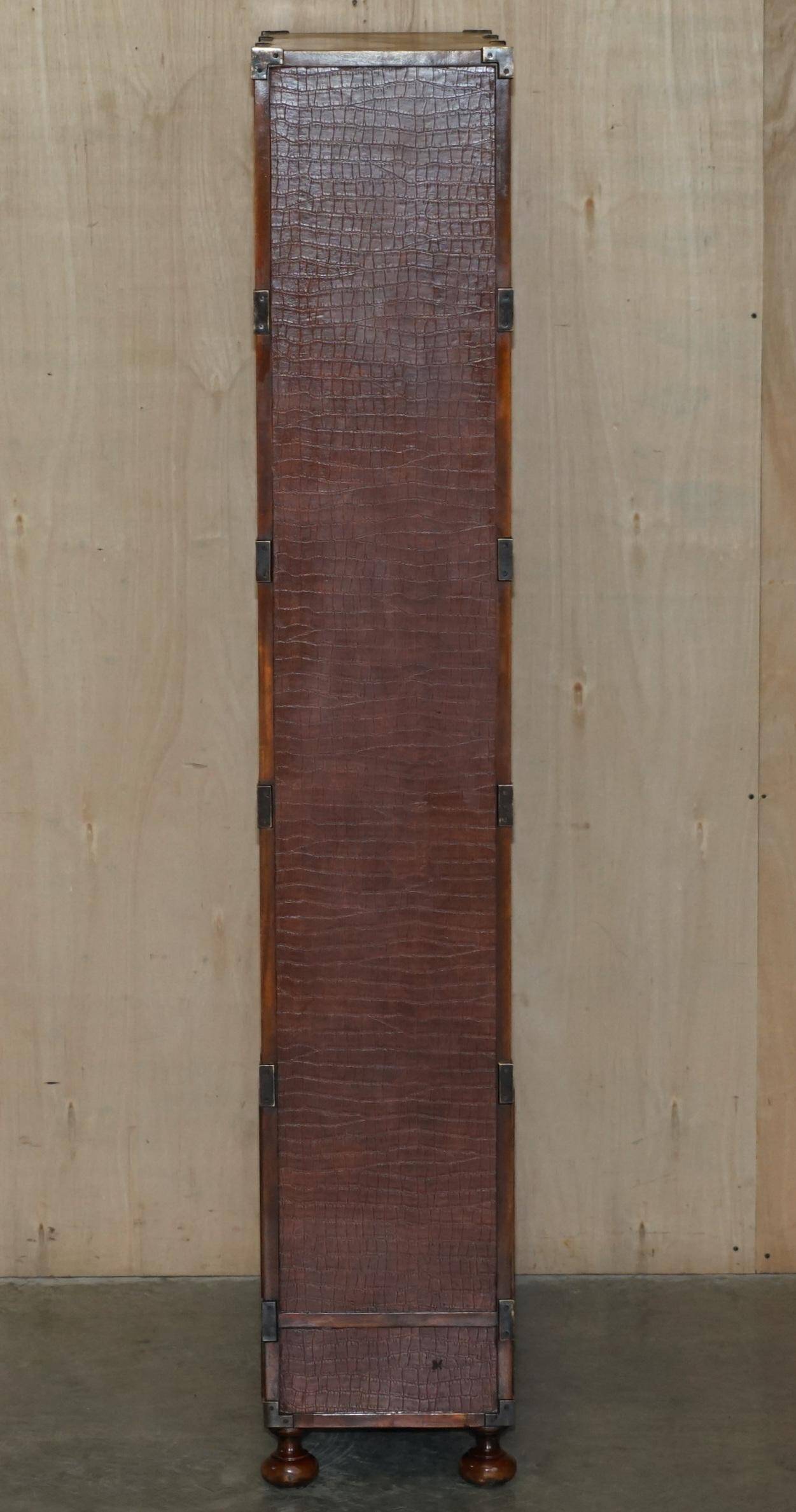 Pair of open bookshelves in crocodile leather with drawers and compartments.