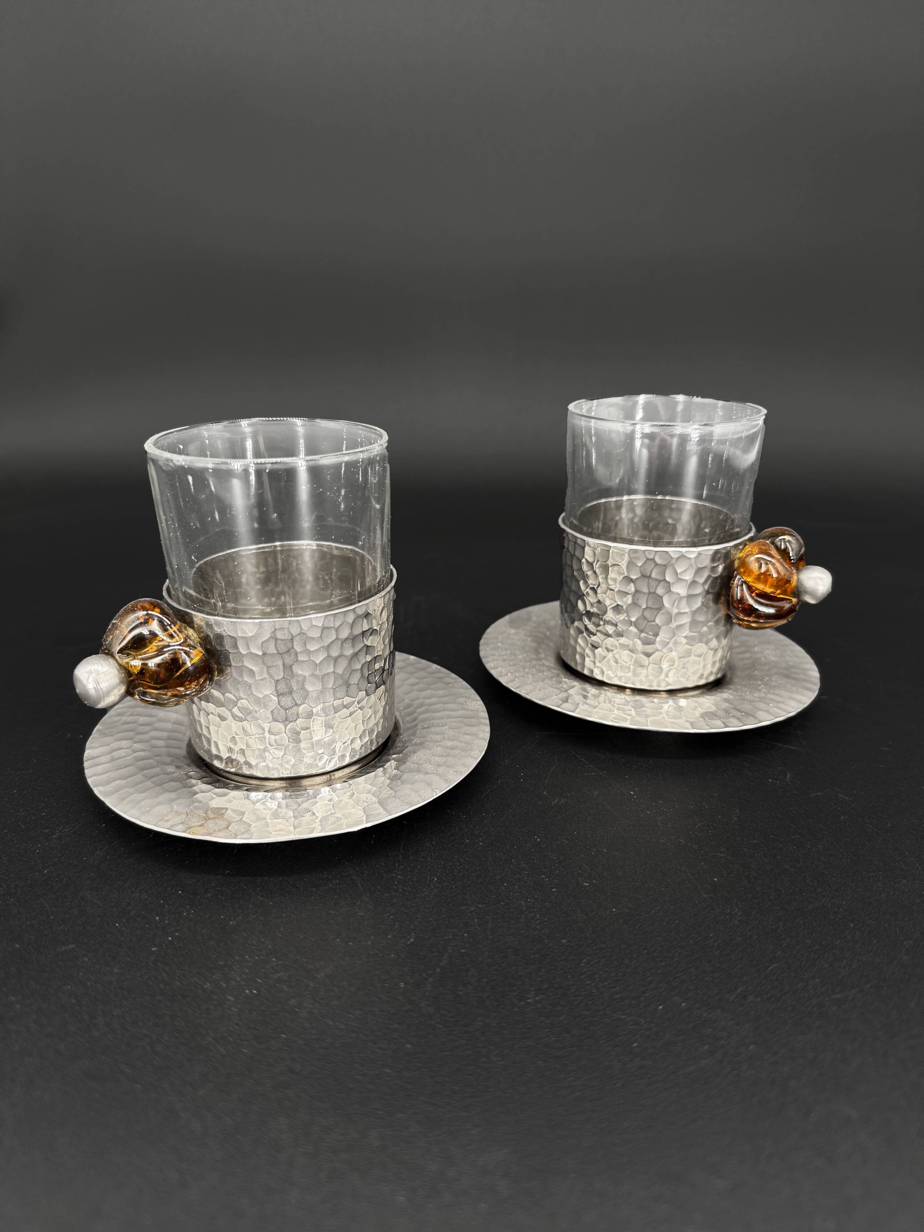 Duo of hammered metal and blown glass cups — handcrafted work