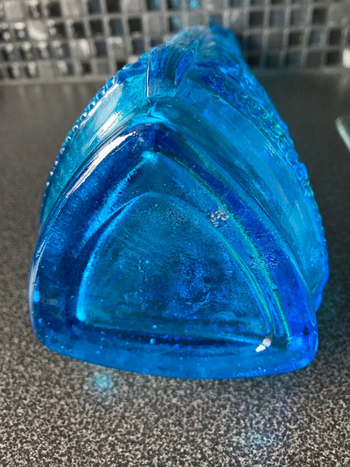 Blue chiseled glass bottle
