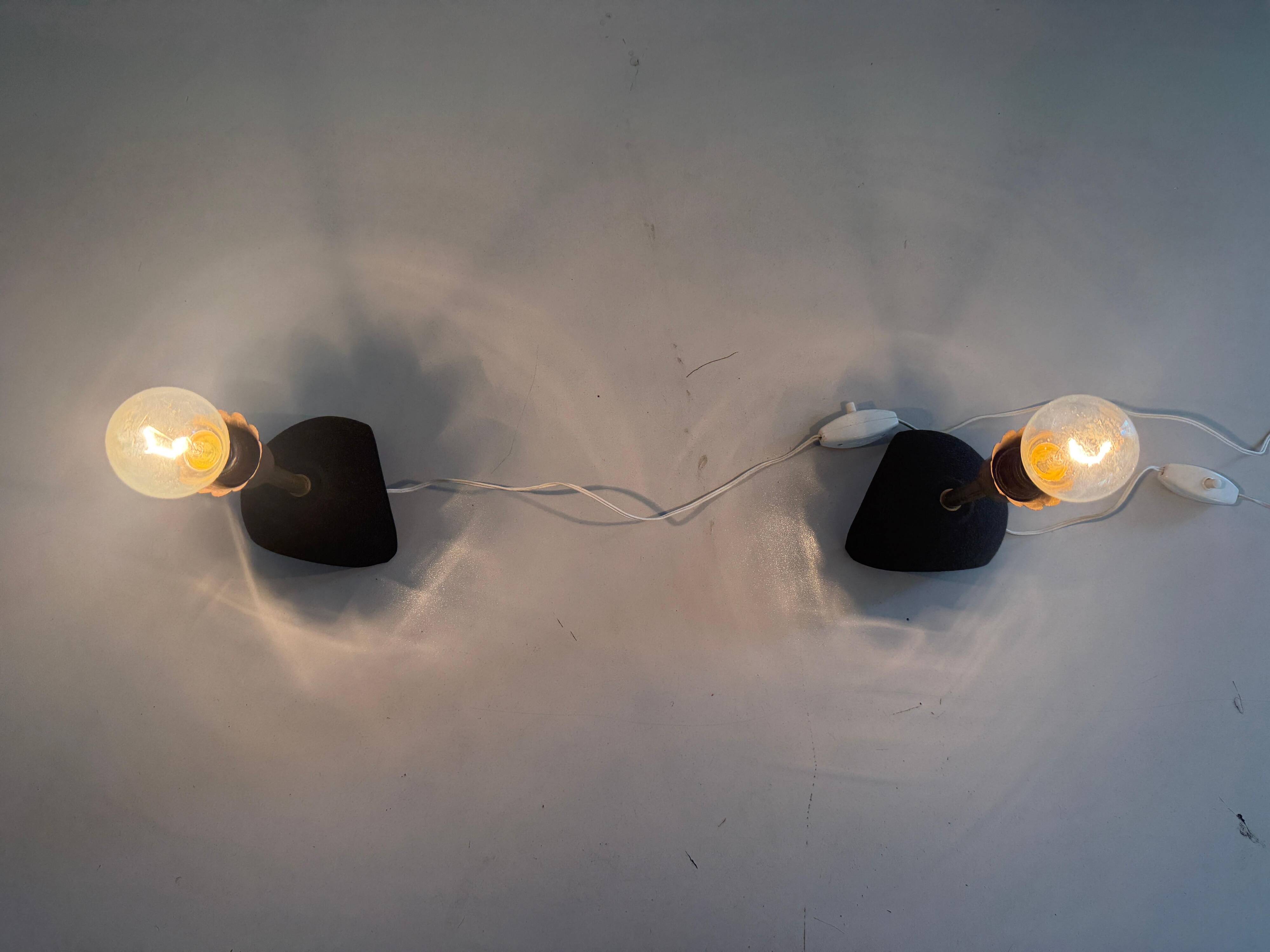 Pair of mid-century bedside lamps in brass and black metal, 1960, Italy