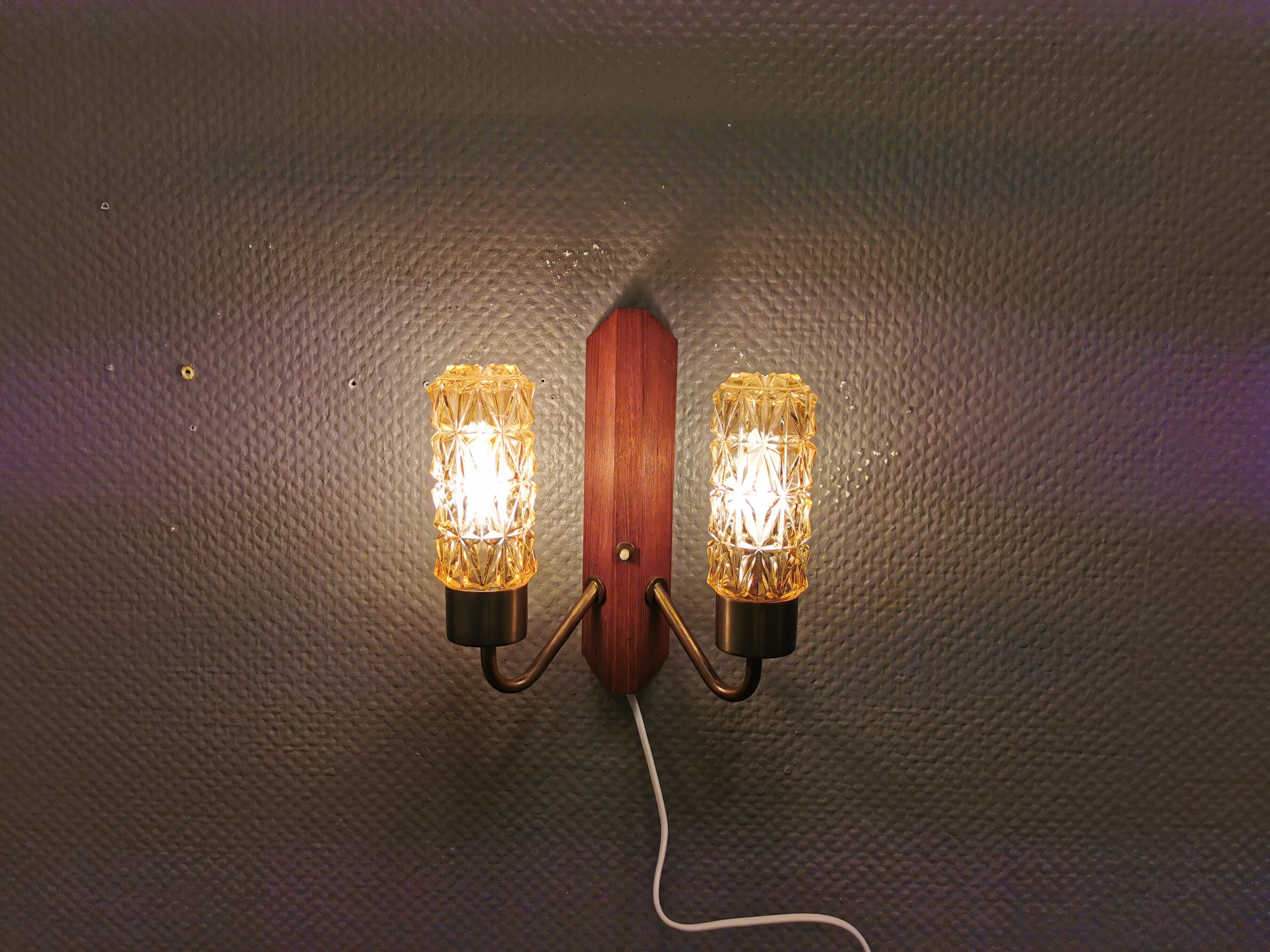 Older Danish wall lamp, with double light source, made of teak wood, amber colored glass and brass