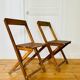 Two vintage wooden folding chairs, circa 1960