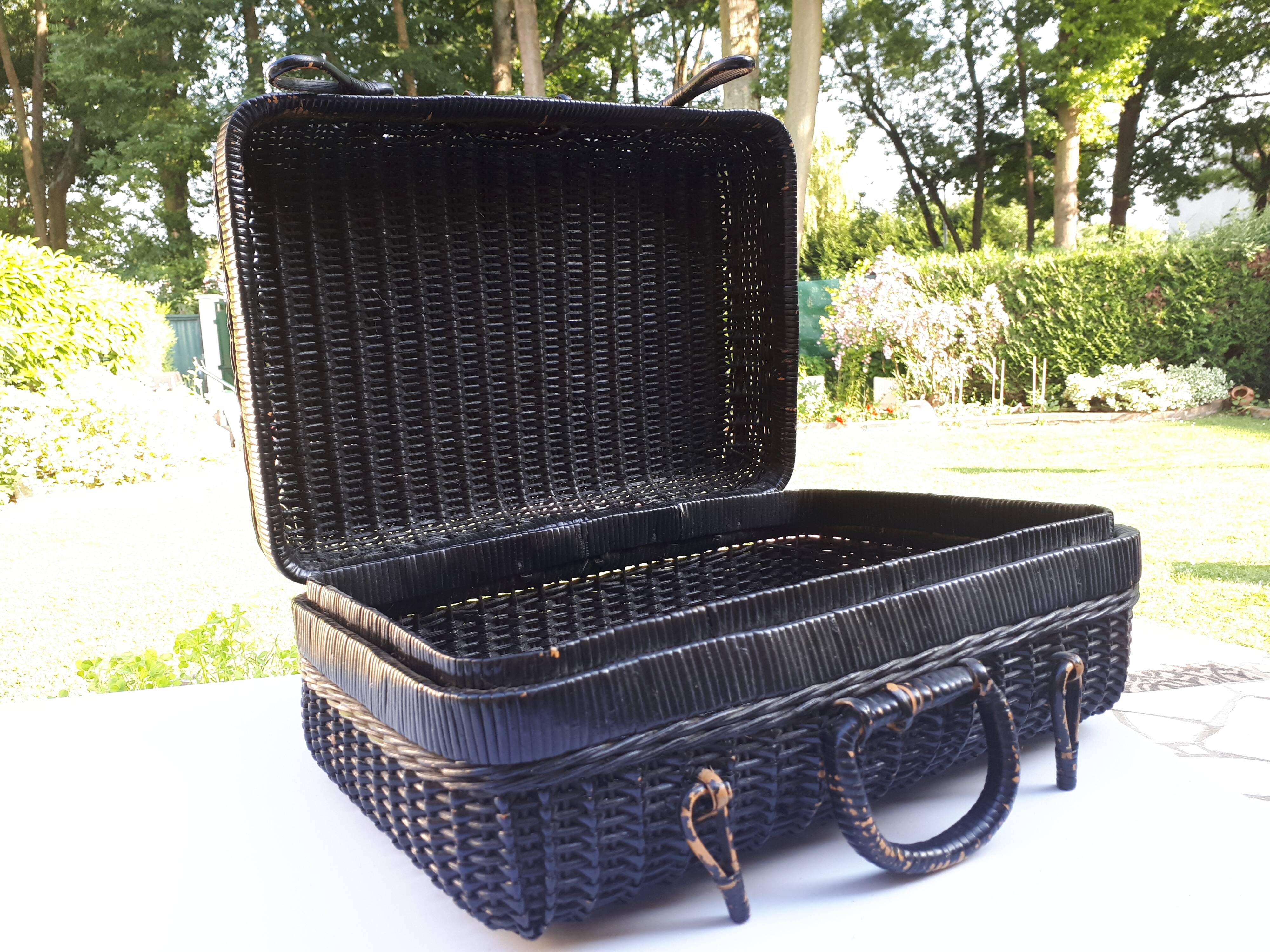 Old black wicker suitcase