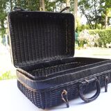 Old black wicker suitcase